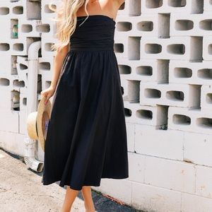 Long black strapless dress.